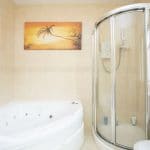 Fully tiled three-piece suite with jacuzzi bath and shower